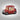 Red toy truck with a snow globe featuring Snoopy and Woodstock on a dark background