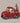 Red toy truck with Santa Claus and reindeer on a dark background