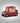 Red toy truck with a snow globe featuring Snoopy and Woodstock on a dark background