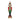 A festive nutcracker figurine standing on a decorated base, dressed in a red and green military-style coat with gold trim, black pants, and a black hat with gold detailing, set against a white bokeh background.