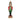 A decorative Christmas nutcracker figurine standing on a snowy surface at night, with blurred holiday lights and a dark outdoor background. The nutcracker wears a red coat with green trim, black pants, and a gold-and-black hat, and stands on a red and gold base.